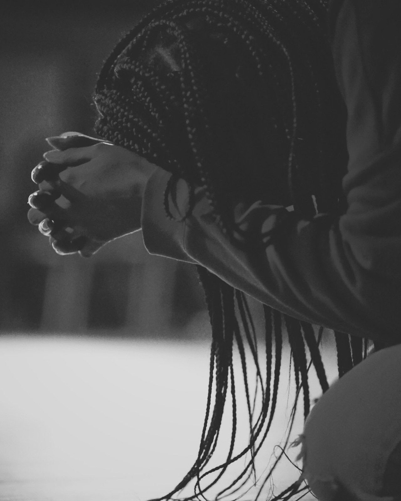 Someone kneeling in prayer during a Kairos service
