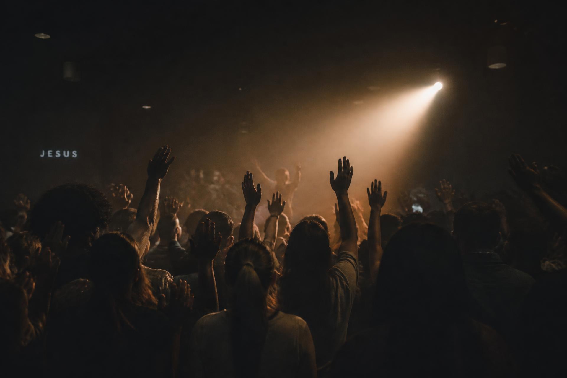 Kairos Tampa gathered in worship with hands raised